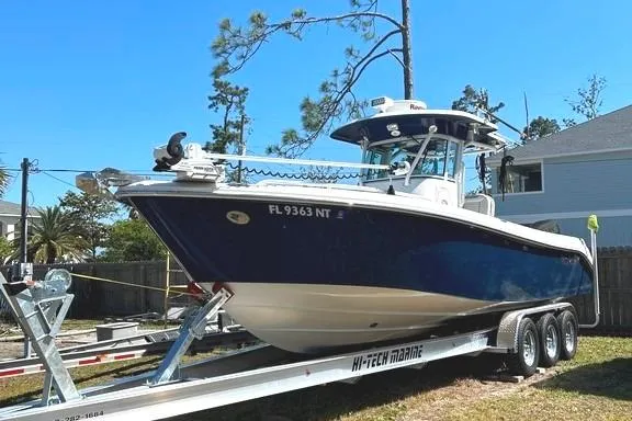 Slide: The Image of 2008 Everglades 290 CC boat on trailer, parked outdoors, clear blue sky. - 2