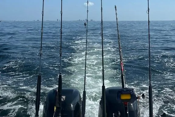 Slide: The Image of Fishing rods on a 2008 Everglades 290 CC boat, ocean view in the background. - 20