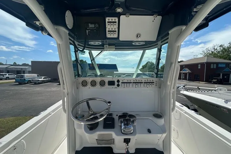 Slide: The Image of 2008 Everglades 290 CC boat cockpit with steering wheel and control panel. - 22