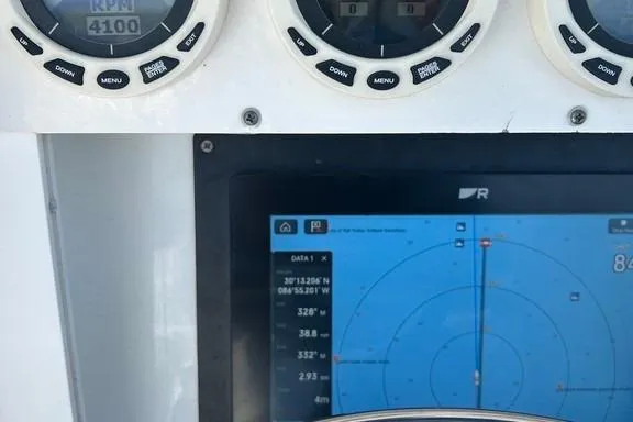 Slide: The Image of Dashboard of a 2008 Everglades 290 CC boat with navigation and RPM displays. - 25