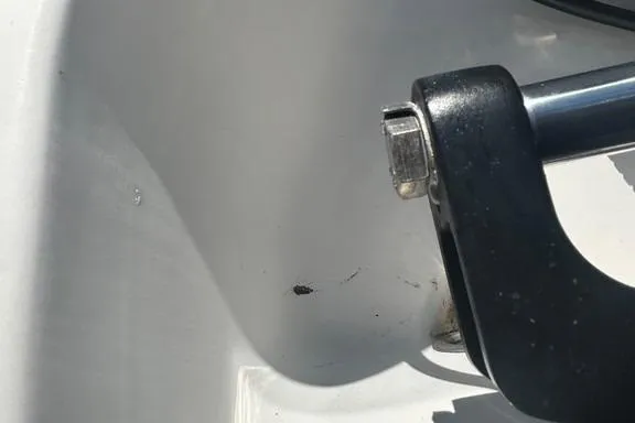 Slide: The Image of Close-up of Everglades 290 CC 2008 boat detail, featuring a metal handle and white surface. - 27