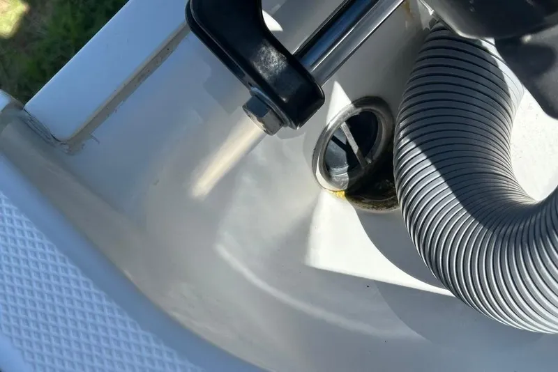 Slide: The Image of Close-up of Everglades 290 CC 2008 boat's drainage area with hose and handle. - 28