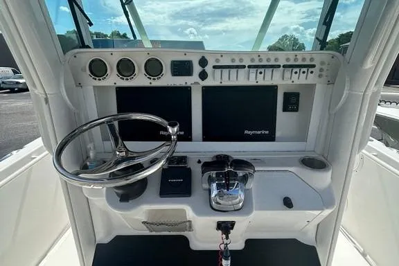 Slide: The Image of 2008 Everglades 290 CC boat dashboard with steering wheel and navigation controls. - 29