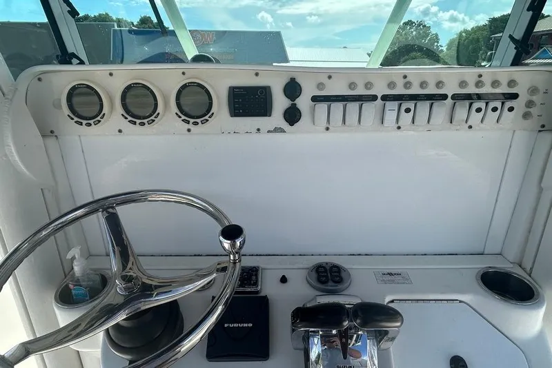 Slide: The Image of 2008 Everglades 290 CC boat dashboard with steering wheel and control panel. - 31