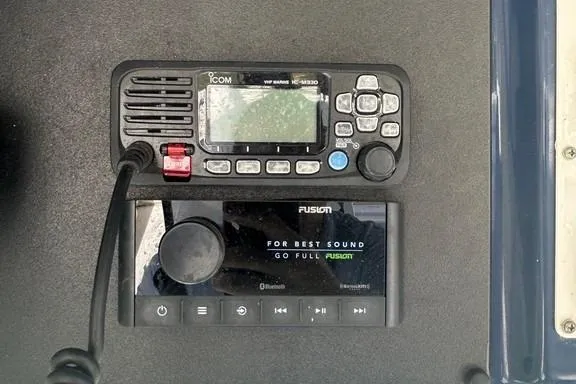 Slide: The Image of 2008 Everglades 290 CC boat radio and audio system, featuring Icom and Fusion devices. - 33