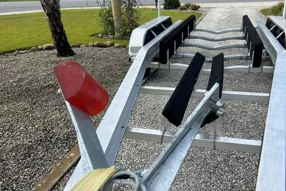 Slide: The Image of Boat trailer for 2008 Everglades 290 CC on gravel driveway. - 35