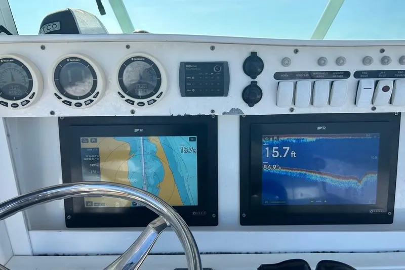 Slide: The Image of Dashboard of a 2008 Everglades 290 CC boat with navigation and depth displays. - 42