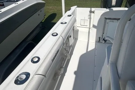 Slide: The Image of 2008 Everglades 290 CC boat interior, featuring white seating and rod holders. - 43