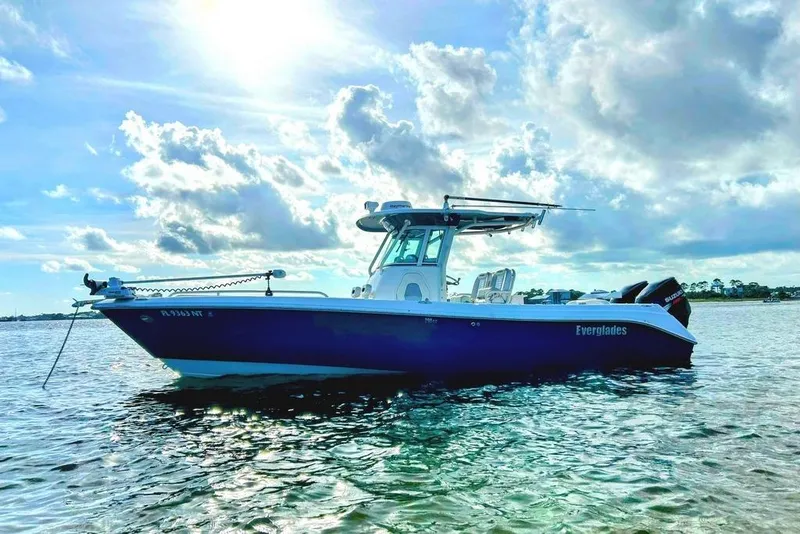 Slide: The Image of 2008 Everglades 290 CC boat on calm water under a bright, cloudy sky. - 48