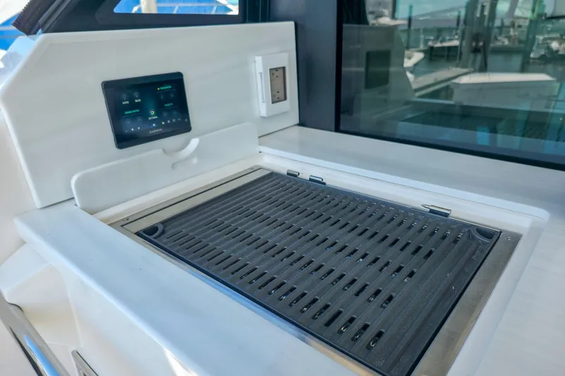 Slide: The Image of Outdoor grill and control panel on 2026 Regal 38 Grande Coupe yacht. - 10