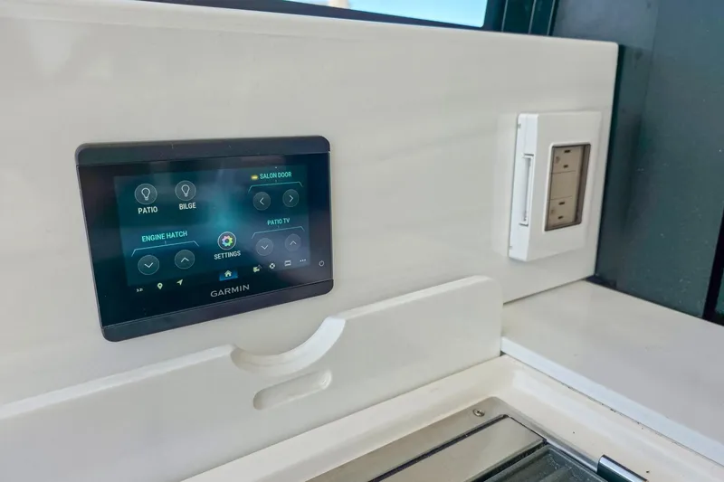 Slide: The Image of Control panel on 2026 Regal 38 Grande Coupe yacht, featuring Garmin touchscreen interface. - 11