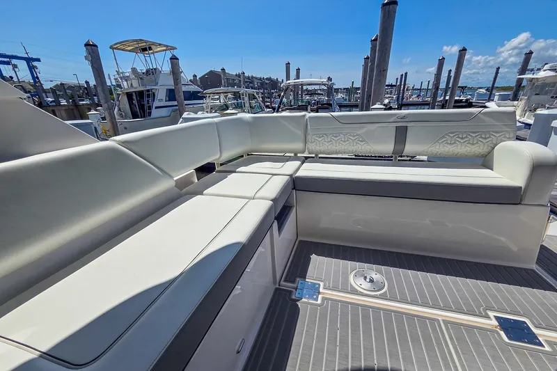Slide: The Image of Luxurious seating on the 2026 Regal 38 Grande Coupe yacht, docked at a marina. - 14