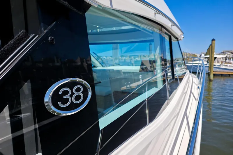 Slide: The Image of 2026 Regal 38 Grande Coupe yacht docked, showcasing sleek design and modern features. - 16