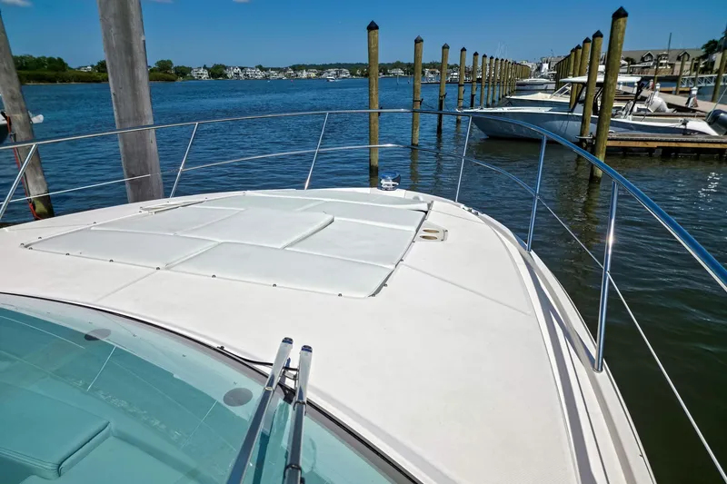 Slide: The Image of 2026 Regal 38 Grande Coupe yacht docked at marina, showcasing sleek deck design. - 18