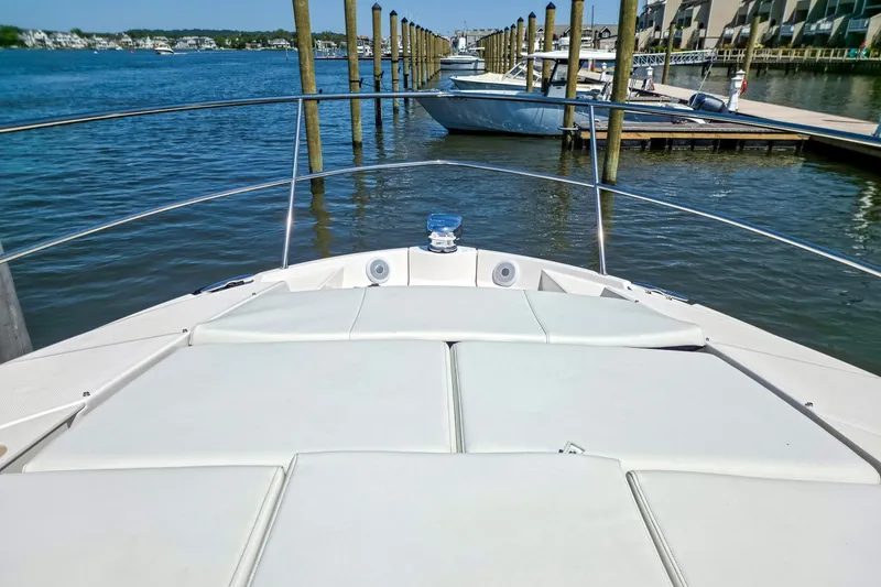 Slide: The Image of 2026 Regal 38 Grande Coupe yacht docked in a serene marina setting. - 19