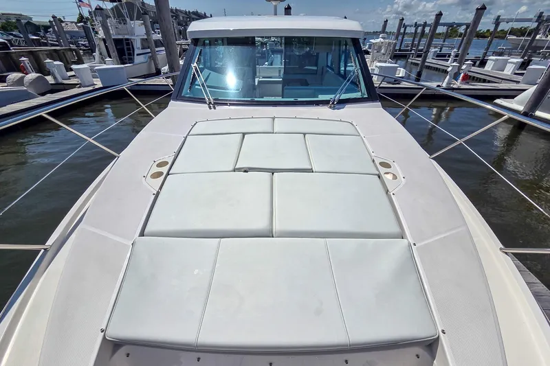 Slide: The Image of 2026 Regal 38 Grande Coupe yacht docked, featuring spacious sunbathing area and sleek design. - 20