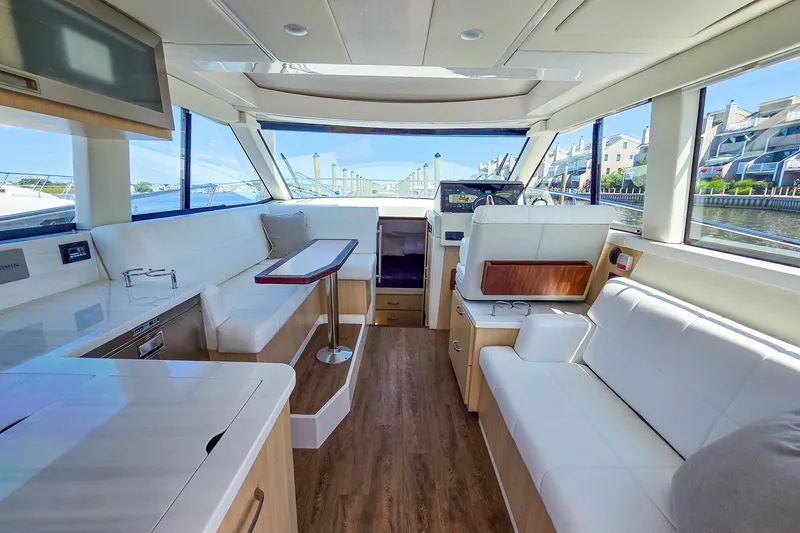 Slide: The Image of Luxurious interior of 2026 Regal 38 Grande Coupe yacht with modern seating and panoramic windows. - 22