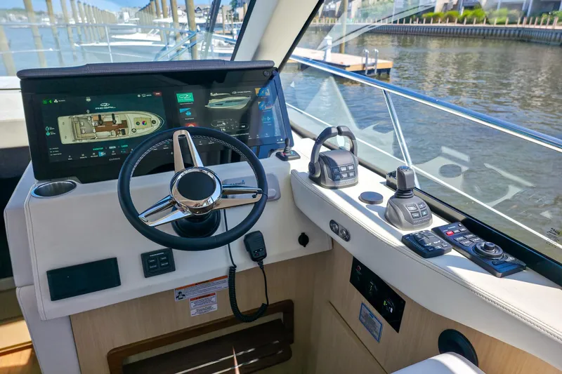 Slide: The Image of Helm of 2026 Regal 38 Grande Coupe with advanced navigation controls and touchscreen display. - 24