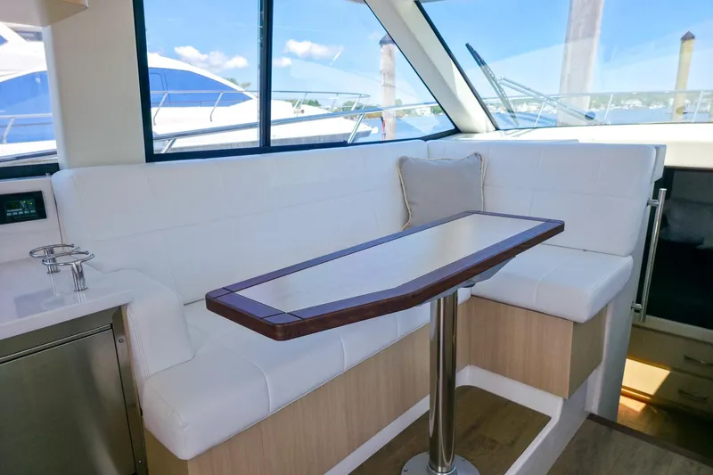 Slide: The Image of Interior of 2026 Regal 38 Grande Coupe with white seating and wooden table. - 25