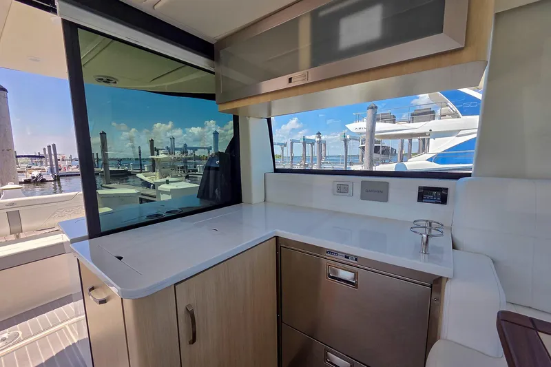 Slide: The Image of Interior view of 2026 Regal 38 Grande Coupe yacht with modern kitchen amenities. - 27