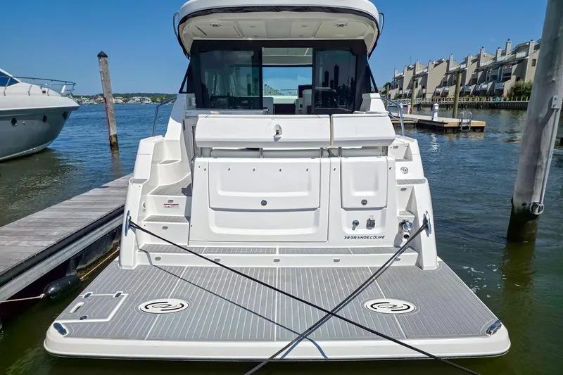 Slide: The Image of 2026 Regal 38 Grande Coupe yacht docked at marina, rear view. - 3