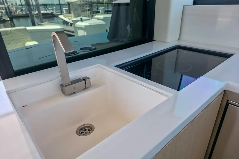 Slide: The Image of Modern kitchen area in 2026 Regal 38 Grande Coupe yacht with sink and stovetop. - 30