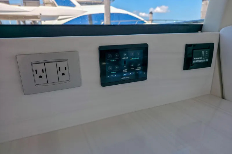 Slide: The Image of Control panel and outlets inside 2026 Regal 38 Grande Coupe yacht interior. - 31