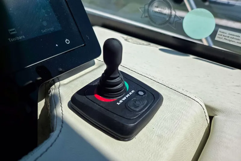 Slide: The Image of Joystick control on 2026 Regal 38 Grande Coupe dashboard, next to touchscreen display. - 38