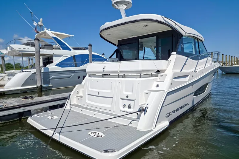 Slide: The Image of 2026 Regal 38 Grande Coupe yacht docked at marina, showcasing sleek design and modern features. - 4