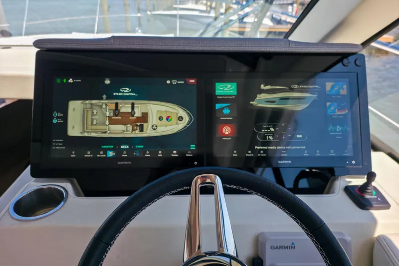 Slide: The Image of 2026 Regal 38 Grande Coupe helm with dual Garmin displays and steering wheel. - 41