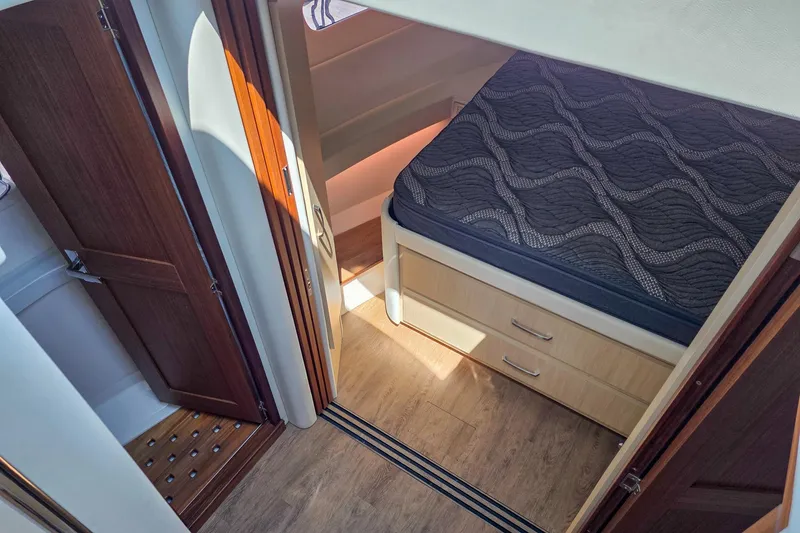 Slide: The Image of 2026 Regal 38 Grande Coupe cabin interior with bed and wooden flooring. - 42