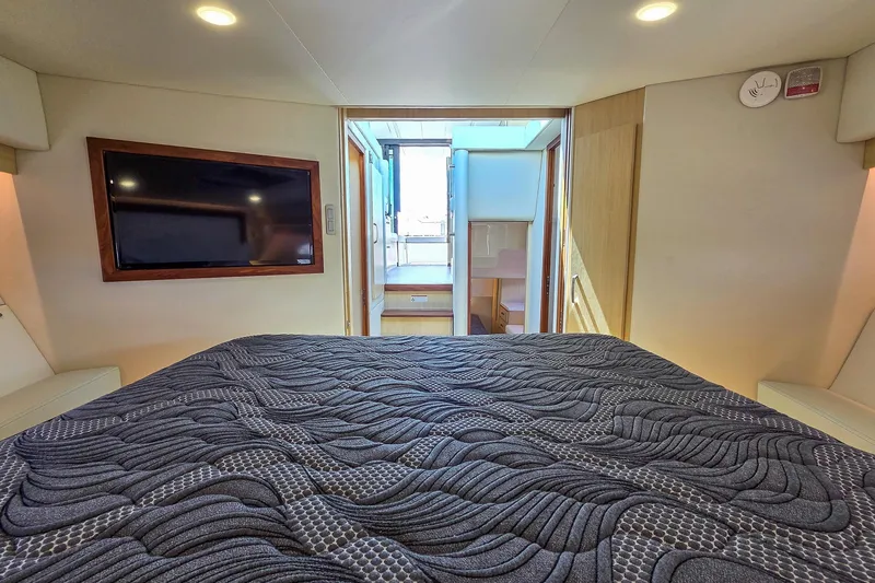 Slide: The Image of Interior of 2026 Regal 38 Grande Coupe with modern bedding and wall-mounted TV. - 47