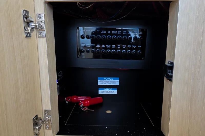 Slide: The Image of Electrical panel inside 2026 Regal 38 Grande Coupe, featuring switches and safety notices. - 51