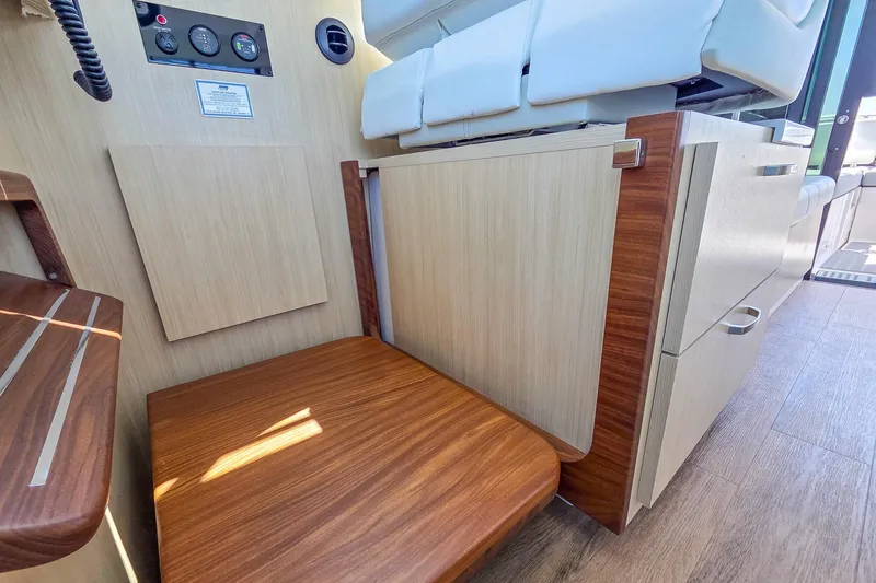 Slide: The Image of Interior of 2026 Regal 38 Grande Coupe showcasing wood finishes and seating area. - 56