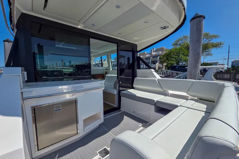 Slide: The Image of 2026 Regal 38 Grande Coupe yacht interior with sleek seating and modern design. - 8