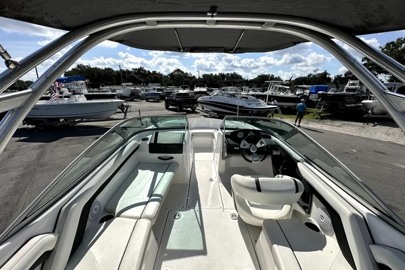 Slide: The Image of 2016 Yamaha Boats AR190 interior view at a marina with multiple boats. - 13