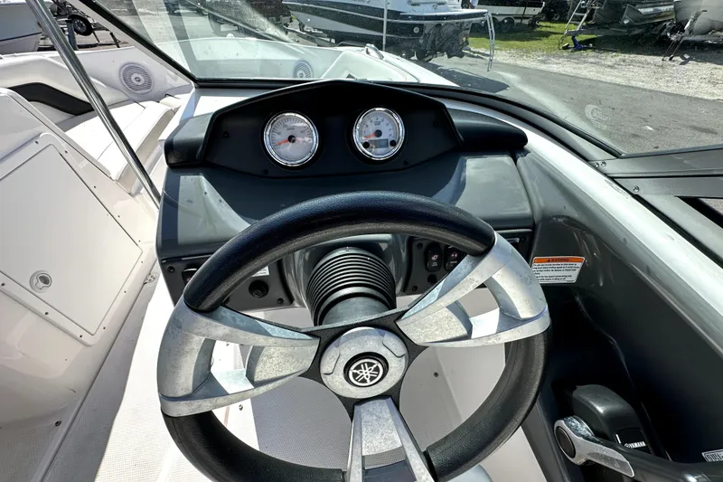 Slide: The Image of 2016 Yamaha Boats AR190 dashboard with steering wheel and gauges in a sleek design. - 18