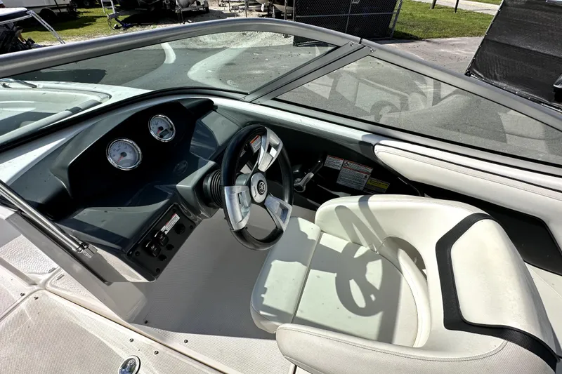 Slide: The Image of 2016 Yamaha Boats AR190 cockpit with steering wheel and gauges, featuring white seating. - 19