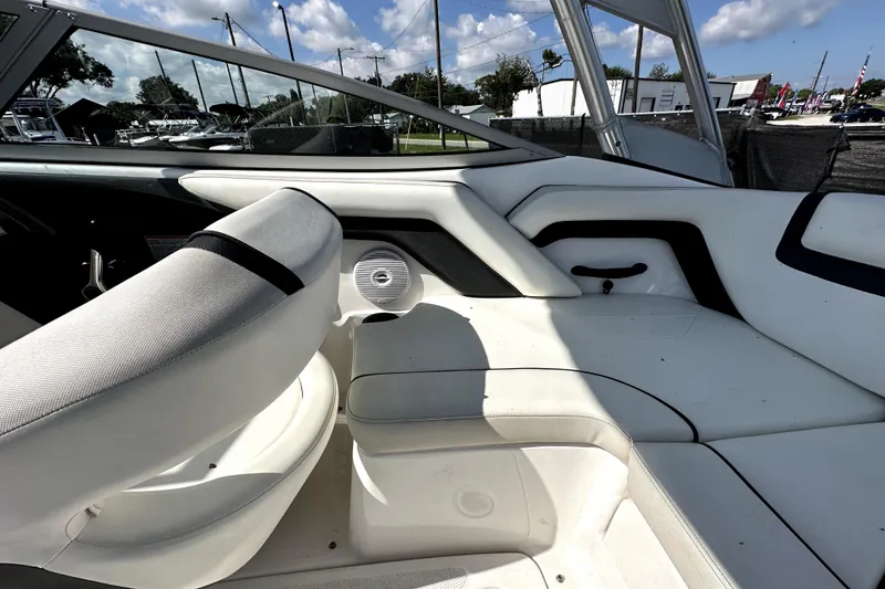 Slide: The Image of 2016 Yamaha Boats AR190 interior with white seating and speaker, under a clear blue sky. - 22