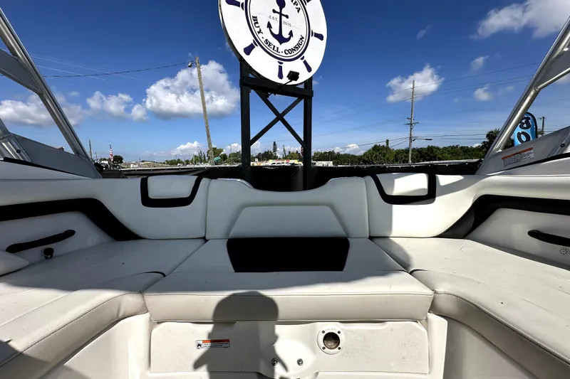 Slide: The Image of 2016 Yamaha Boats AR190 interior with white seating under a clear blue sky. - 25