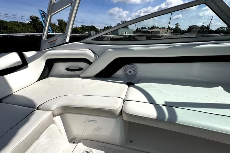 Slide: The Image of 2016 Yamaha Boats AR190 interior with white seating and speaker, under sunny sky. - 29