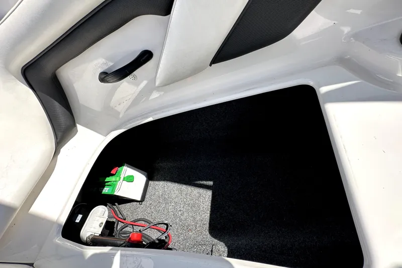 Slide: The Image of 2016 Yamaha AR190 boat storage compartment with battery and wiring. - 30
