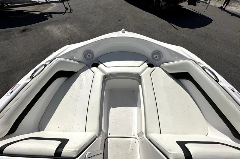 Slide: The Image of 2016 Yamaha Boats AR190 bow seating area with white upholstery and speakers. - 36