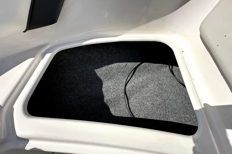 Slide: The Image of Storage compartment in a 2016 Yamaha Boats AR190, featuring a carpeted interior. - 39