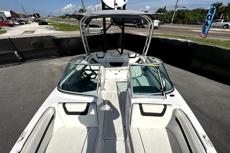 Slide: The Image of 2016 Yamaha Boats AR190, white interior, parked outdoors, showcasing seating and steering area. - 41