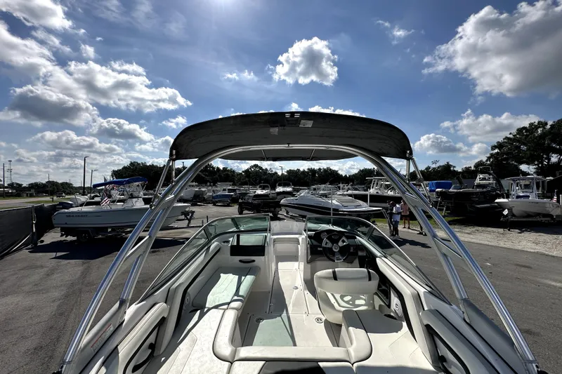 Slide: The Image of 2016 Yamaha AR190 boat with canopy, parked under a sunny sky at a marina. - 9