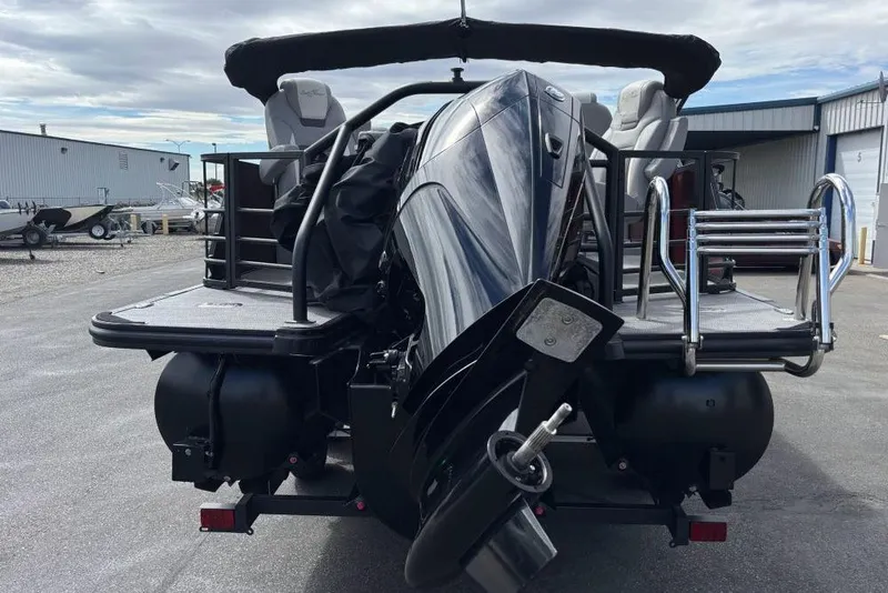 Slide: The Image of 2025 SunChaser Eclipse 23 Fish pontoon boat, rear view with motor and ladder. - 2