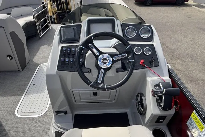 Slide: The Image of 2025 SunChaser Eclipse 23 Fish boat dashboard with steering wheel and control panel. - 3