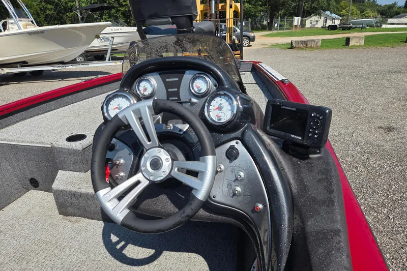 Slide: The Image of 2022 Tracker Pro Team 175 TXW boat dashboard with steering wheel and gauges. - 13