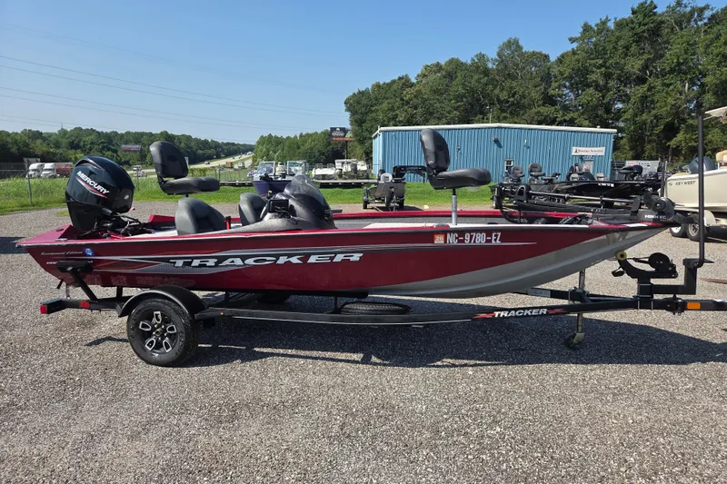 Slide: The Image of 2022 Tracker Pro Team 175 TXW boat on trailer, parked outdoors. - 2